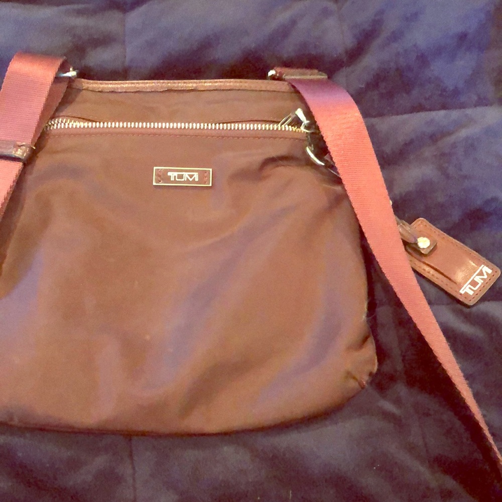 Tumi crossbody maroon bag.